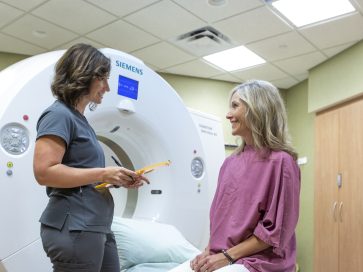 Article image: Imaging & Radiology - Technologist helping patient with MRI at CCM Health