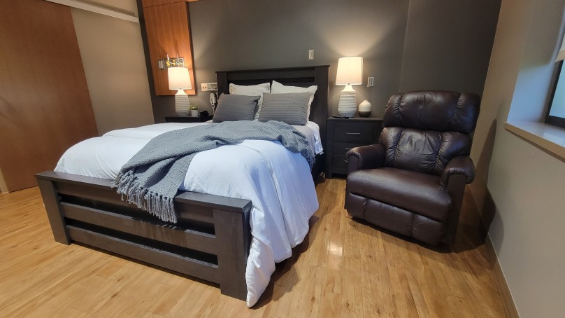 Image of OB Suite with queen-size bed and leather recliner - CM Health OB Suites