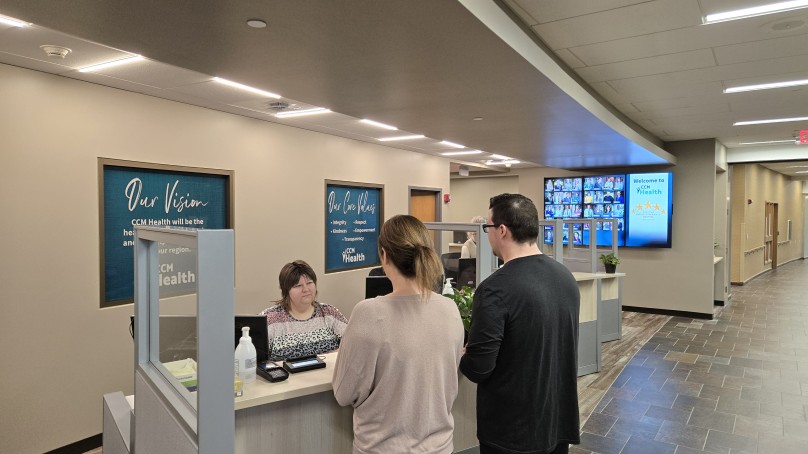 Patient checking in at Patient Registration Desk - CCM Health Montevideo Clinic