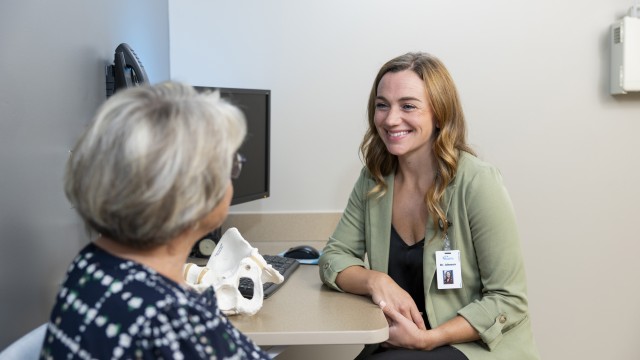 Image of physician speaking with patient in clinic exam room - CCM Health Services
