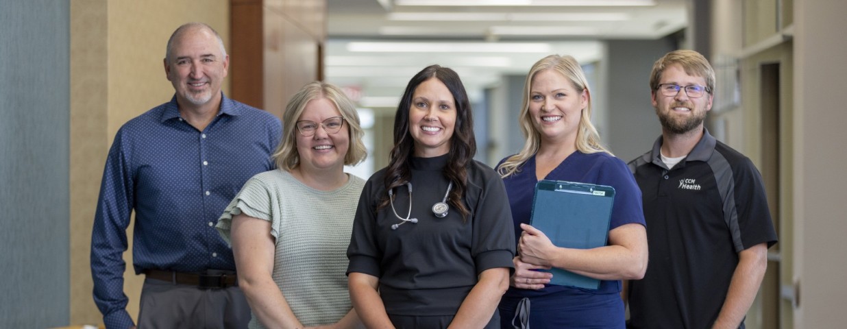 Photo of five CCM Health employees in a row - CCM Health Staff